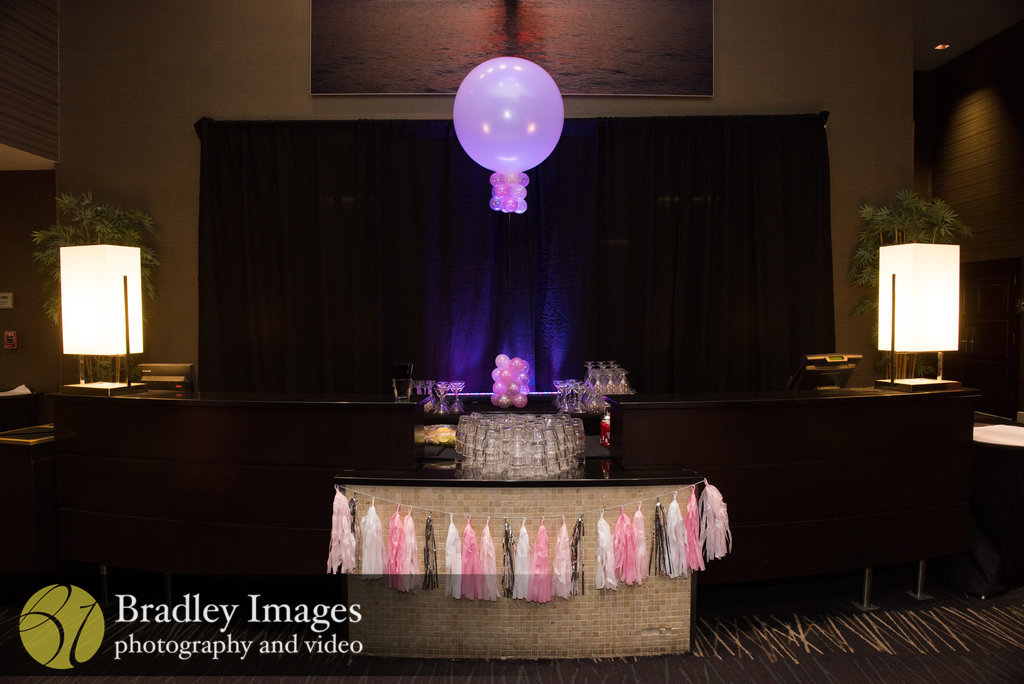 Bar with tassels and balloons at Lindsey's pink book themed Bat Mitzvah party at DoubleTree Bethesda | Pop Color Events | Adding a Pop of Color to Bar & Bat Mitzvahs in DC, MD & VA | Photo by Bradley Images