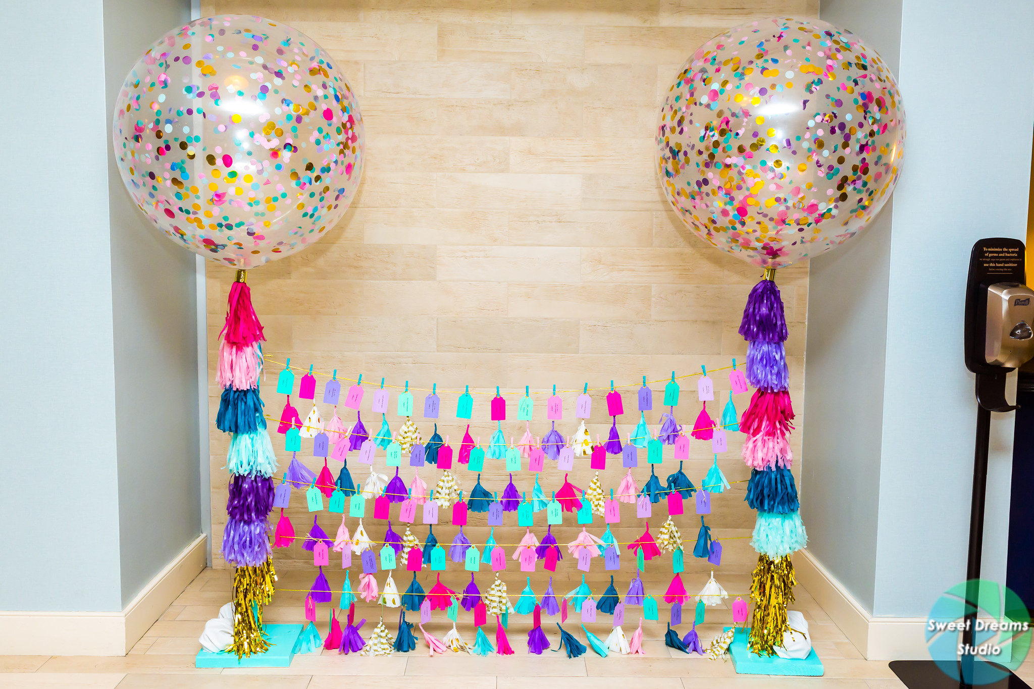 Liv it Up tasseled balloon escort card holder at Olivia's colorful, jewel-toned, balloon-filled Bat Mitzvah party at Hyatt Regency Dulles. Pink, purple, teal, turquoise and gold. | Pop Color Events | Adding a pop of color to Bar & Bat Mitzvahs in DC, MD & VA | Photo by Sweet Dreams Studios