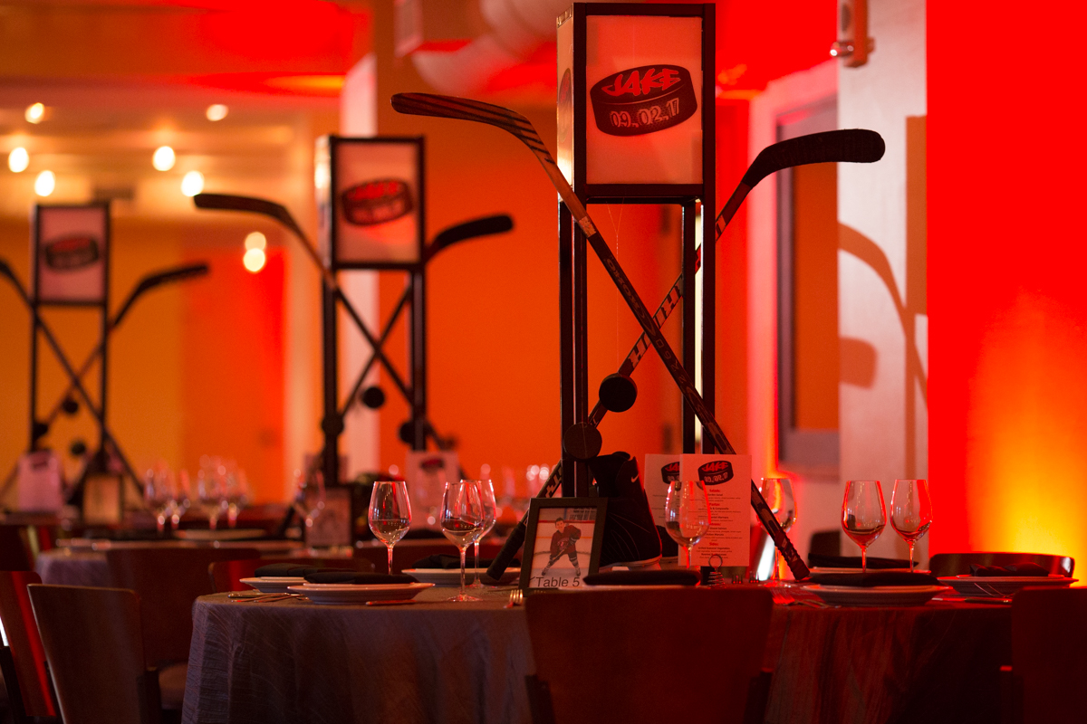 Hockey centerpieces at Jake's Pinstripes Georgetown DC Red and Black Hockey-themed Bar Mitzvah Party | Pop Color Events | Adding a pop of color to Bar & Bat Mitzvahs in DC, MD & VA | Photo by Susan Hornyak Photography