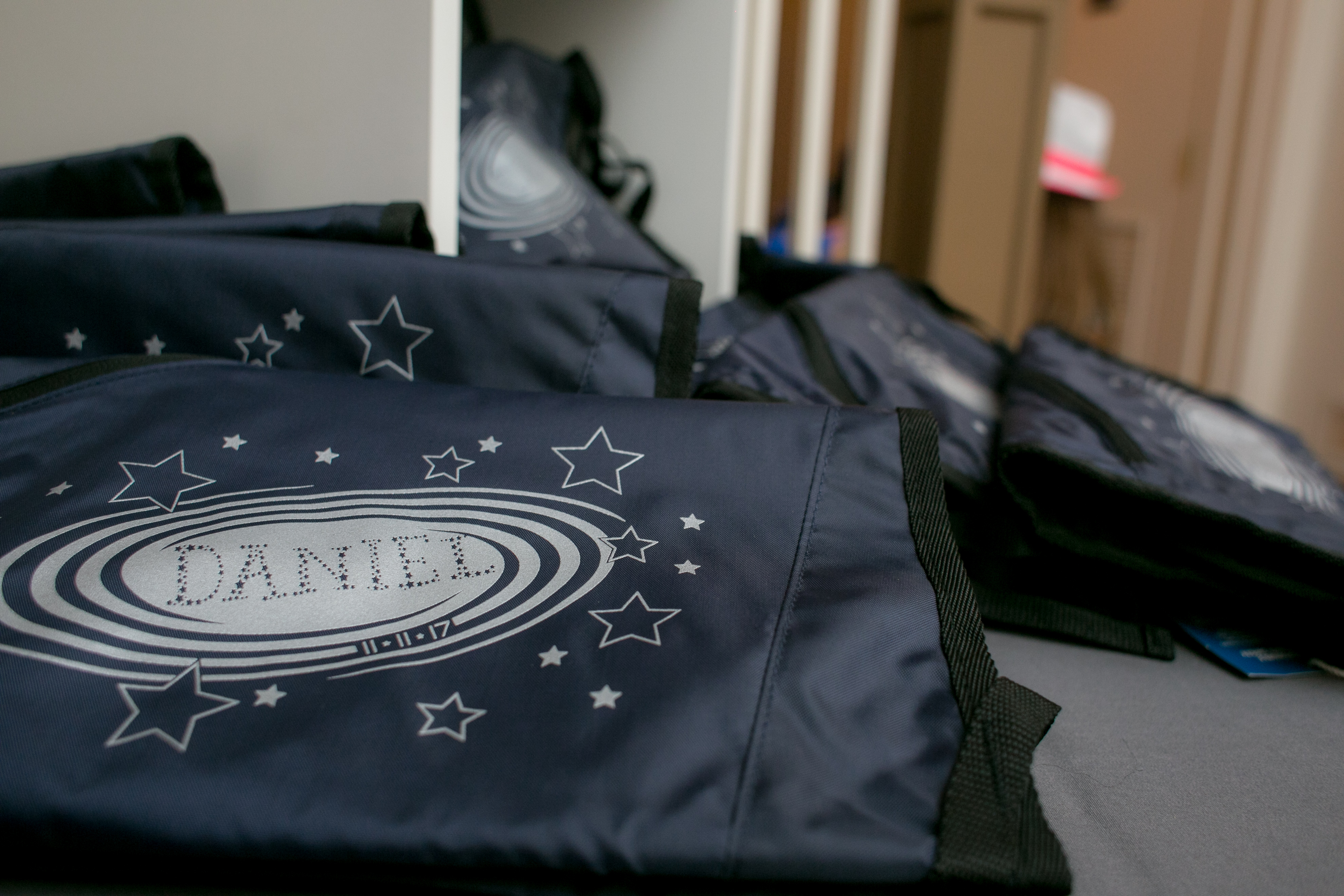 Drawstring book bag favors at Daniel's Outer Space Bar Mitzvah Party at Rock Creek Mansion in Bethesda, MD | Pop Color Events | Adding a Pop of Color to Bar & Bat Mitzvahs in DC, MD & VA | Photo Credit: Michael Temchine Photography