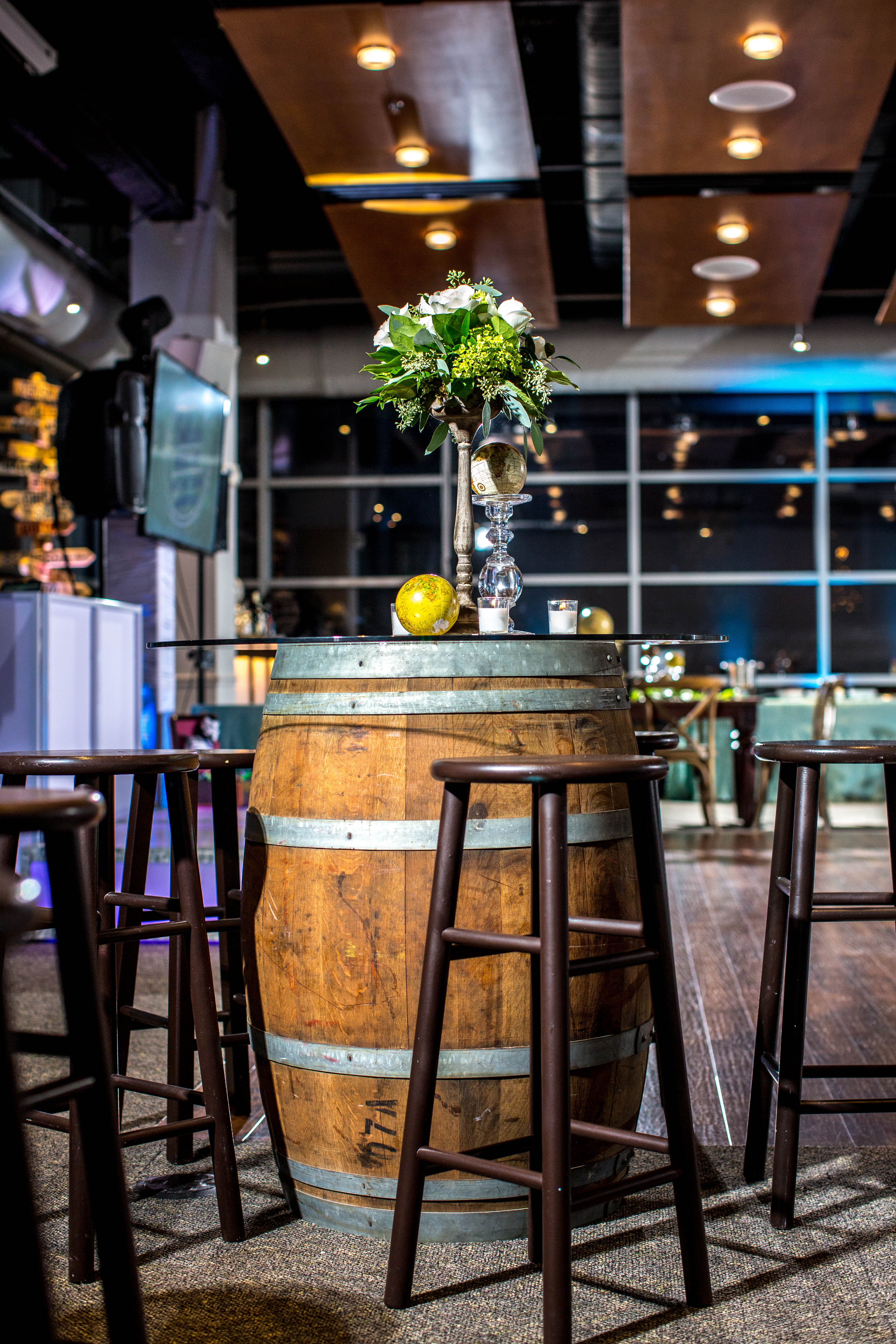 Barrel high tops, flowers and globe centerpieces for Gabriela's global, vintage travel Bat Mitzvah party at VisArts in Rockville, Maryland | Pop Color Events | Adding a Pop of Color to Bar & Bat Mitzvahs in DC, MD & VA | Photo by Michael Temchine Photography