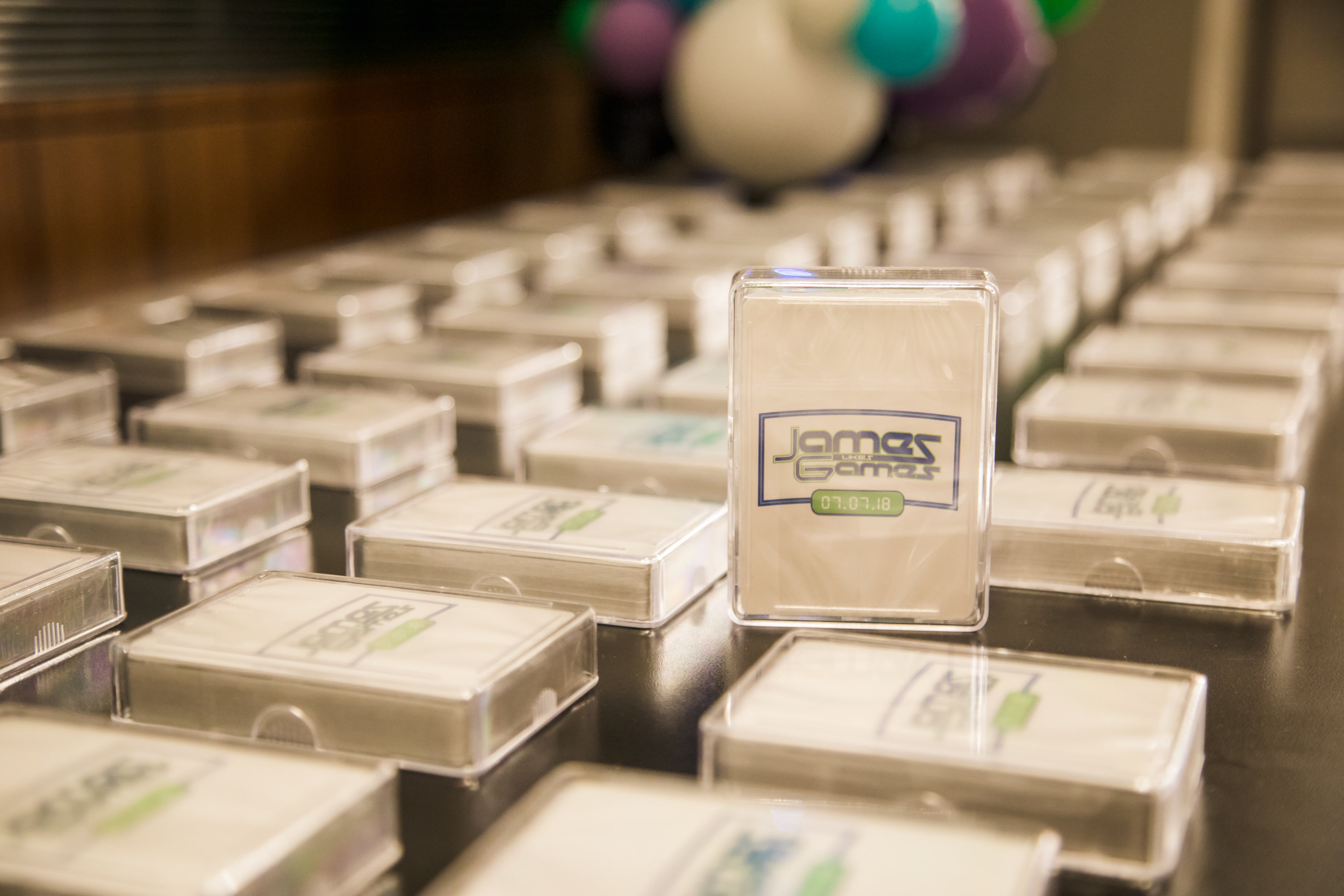 Playing card favors at James's Games-themed Bar Mitzvah party at Hyatt Regency Tysons Corner with balloons, arcade games and playing cards in Northern Virginia. | Pop Color Events | Adding a Pop of Color to Bar & Bat Mitzvahs in DC, MD & VA | Photo by Bradley Images