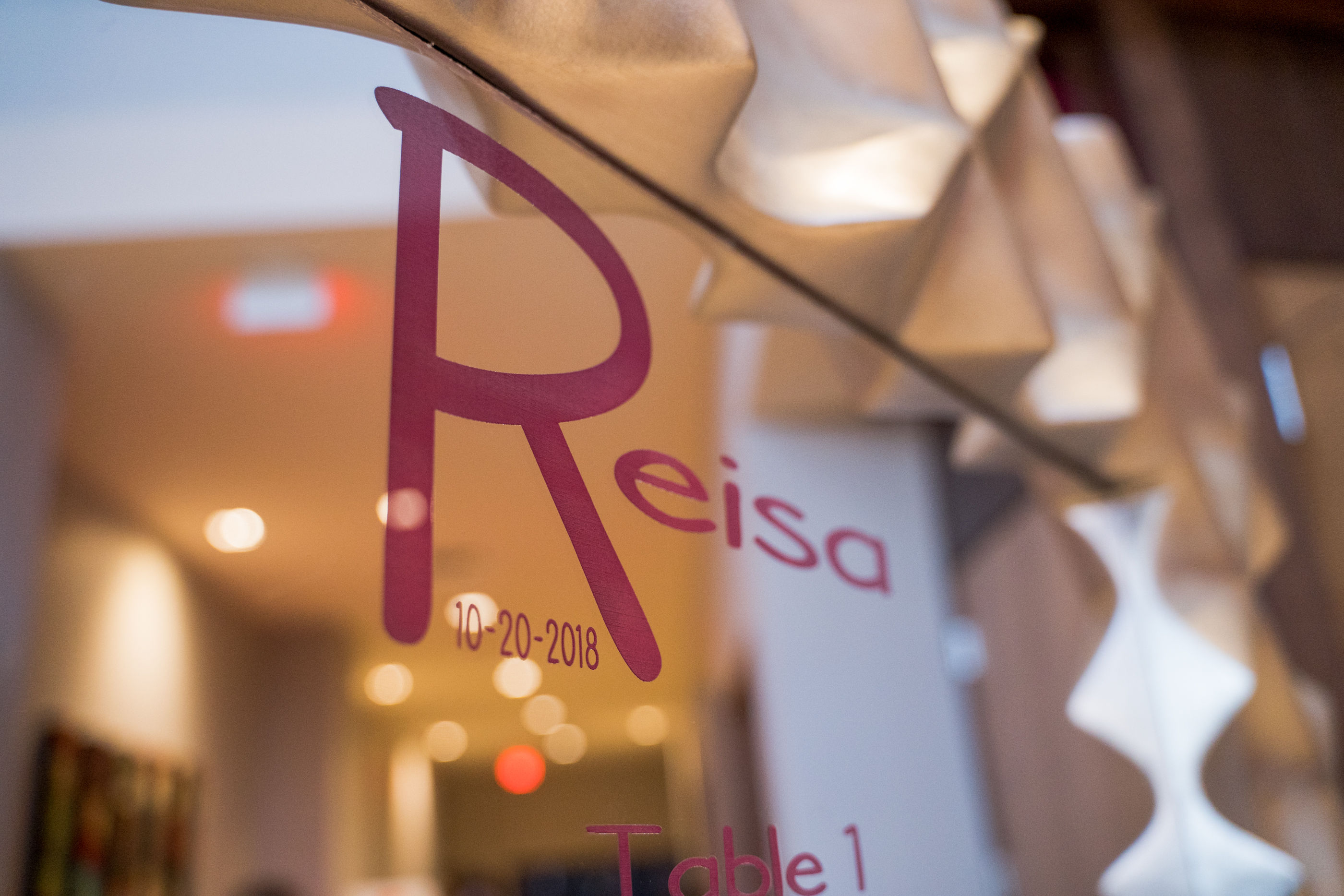 Mirrored seating chart at Reisa's colorful pink and orange Bat Mitzvah at Pinstripes Pike and Rose Bethesda | Pop Color Events | Adding a Pop of Color to Bar & Bat Mitzvahs in DC, MD & VA | Photo by Bradley Images