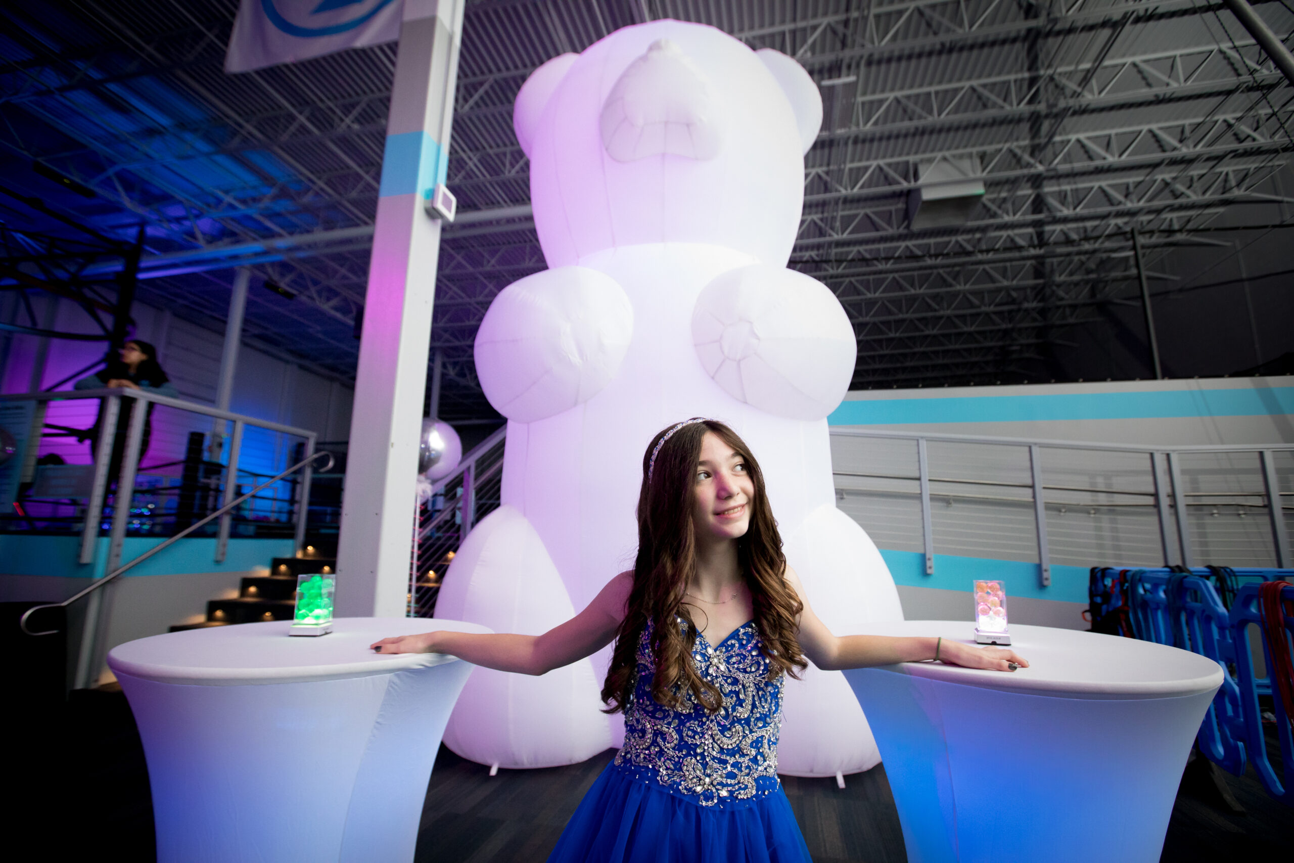 Ava with a giant, 12' bear | AvaZone Magical Whimsical Fantasy themed Bat Mitzvah party with bears, lighting, lounge furniture, cotton candy, unicorn tables and more at ZavaZone in Sterling VA | Photography by Jessica Latos Photography