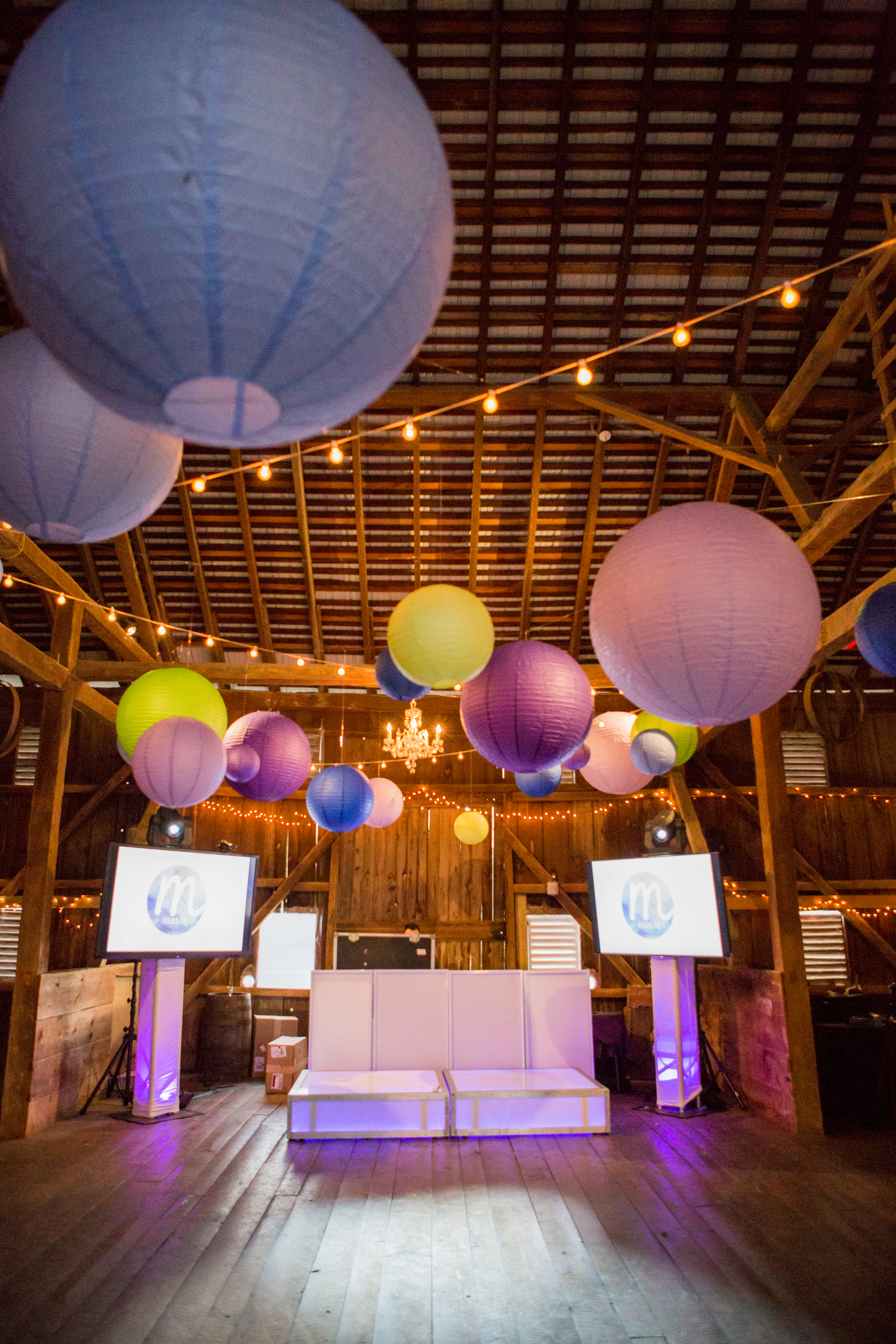 DJ set up with paper lanterns and string lights at Maddie's Rustic Pink and purple Bat Mitzvah at Rocklands Farms in Poolsville, MD | Pop Color Events | Adding a Pop of Color to Bar & Bat Mitzvahs in DC, MD, and VA | Photo by Jessica Latos Photography