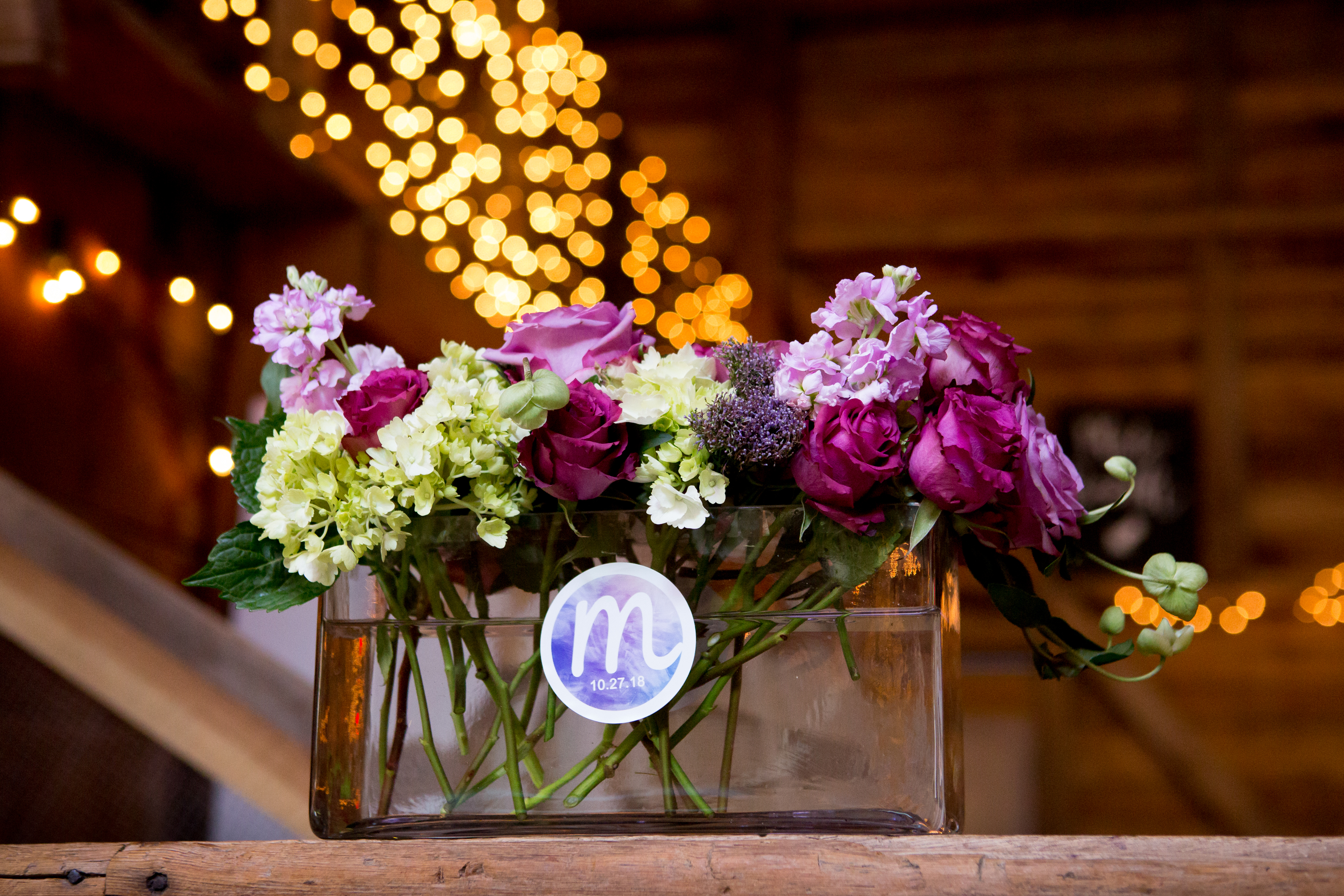 Flowers with logo stickers at Maddie's Rustic Pink and purple Bat Mitzvah at Rocklands Farms in Poolsville, MD | Pop Color Events | Adding a Pop of Color to Bar & Bat Mitzvahs in DC, MD, and VA | Photo by Jessica Latos Photography