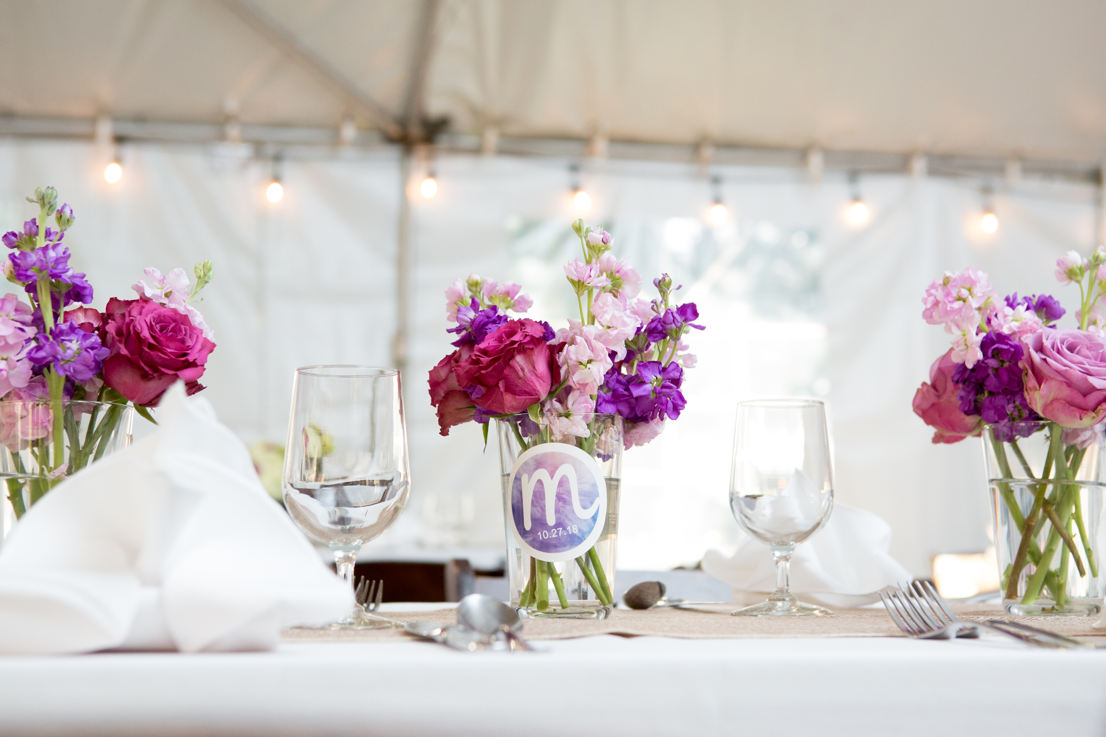 Centerpieces and table numbers at Maddie's Rustic Pink and purple Bat Mitzvah at Rocklands Farms in Poolsville, MD | Pop Color Events | Adding a Pop of Color to Bar & Bat Mitzvahs in DC, MD, and VA | Photo by Jessica Latos Photography