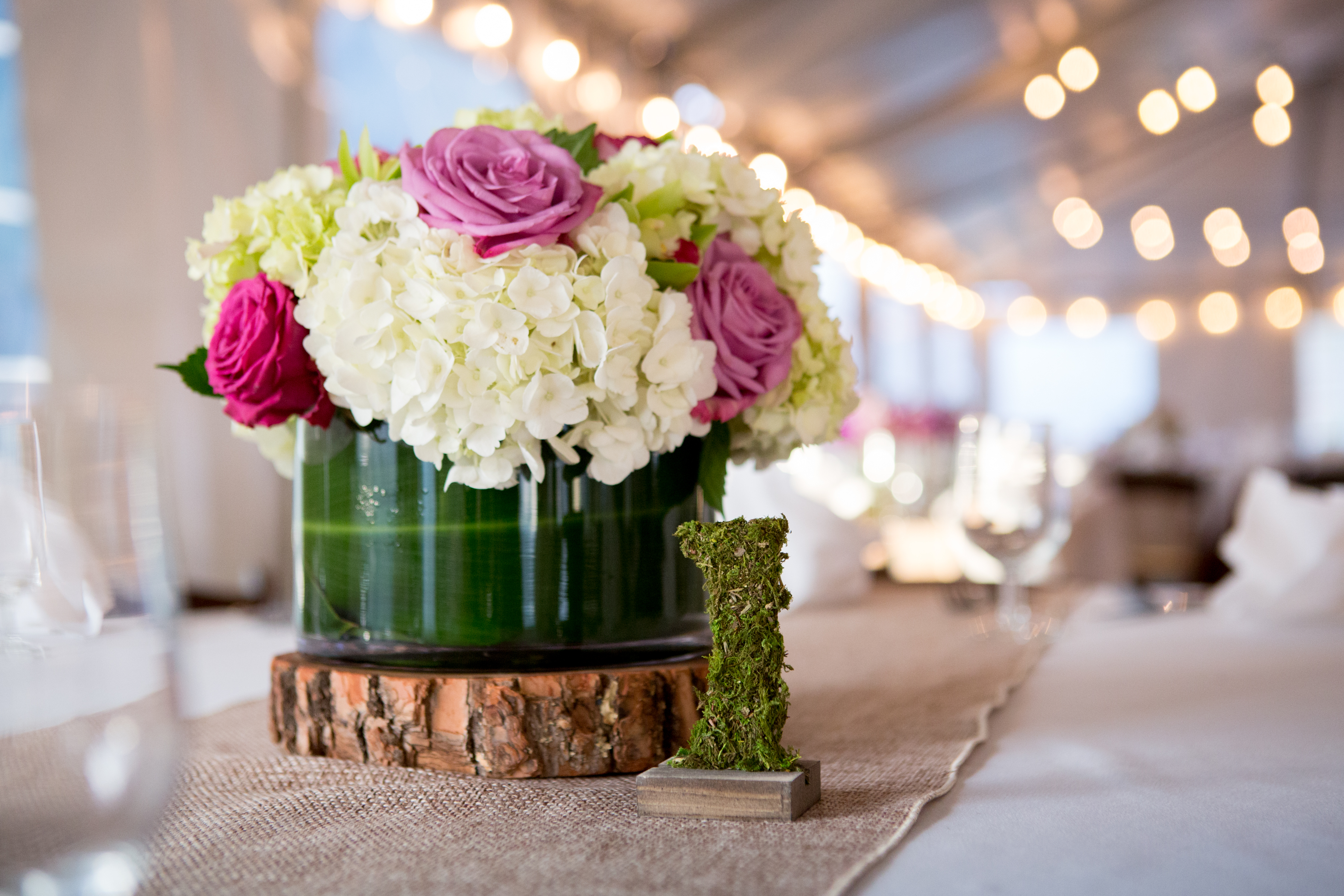 Centerpieces and table numbers at Maddie's Rustic Pink and purple Bat Mitzvah at Rocklands Farms in Poolsville, MD | Pop Color Events | Adding a Pop of Color to Bar & Bat Mitzvahs in DC, MD, and VA | Photo by Jessica Latos Photography