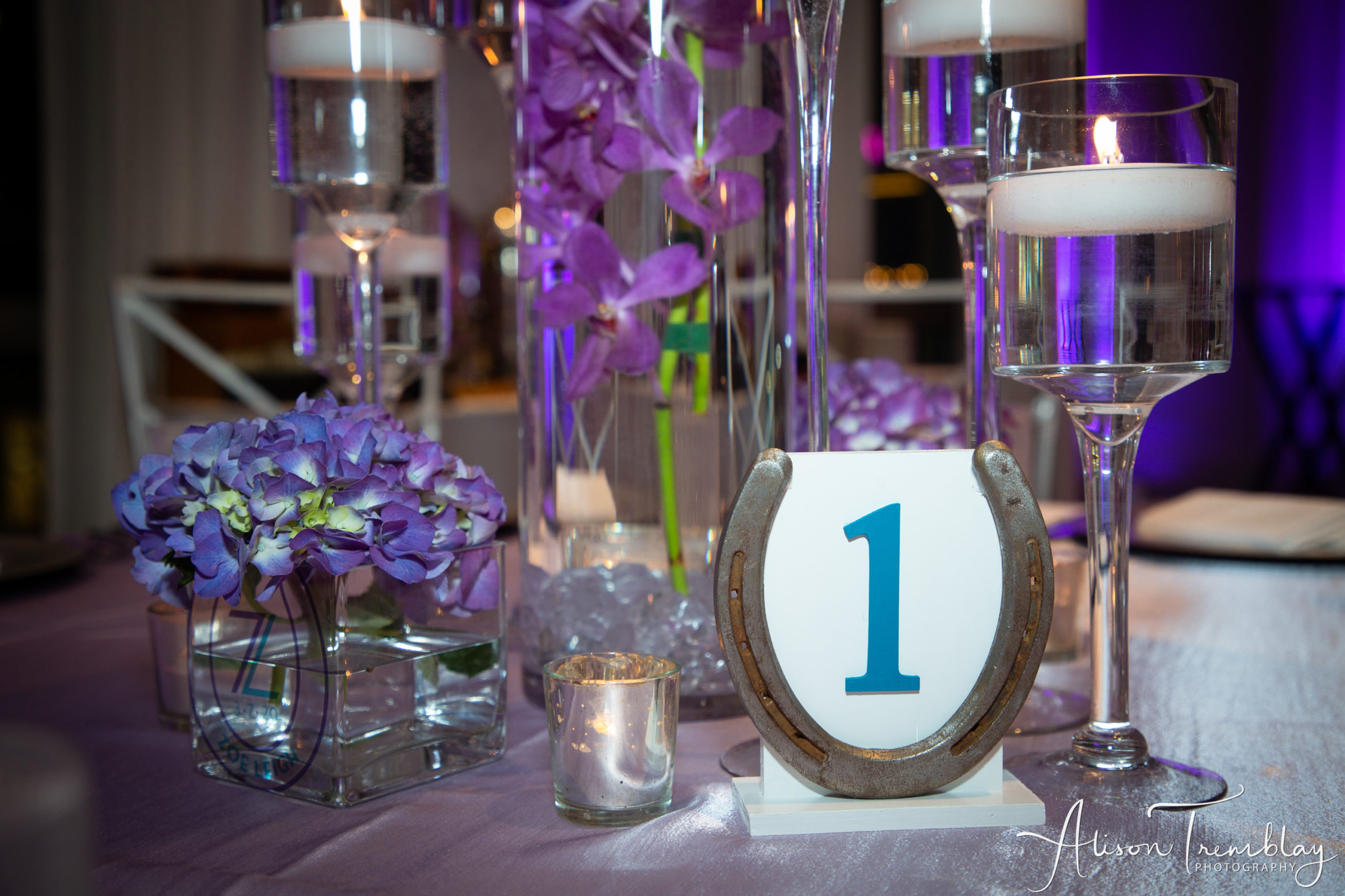 Floral centerpieces and horse shoe table numbers at Zoe's Purple and Teal Equestrian Bat Mitzvah at Canopy by Hilton Washington DC Bethesda North | Pop Color Events | Adding a Pop of Color to Bar & Bat Mitzvahs in DC, MD & VA | Photo by: Alison Tremblay Photography