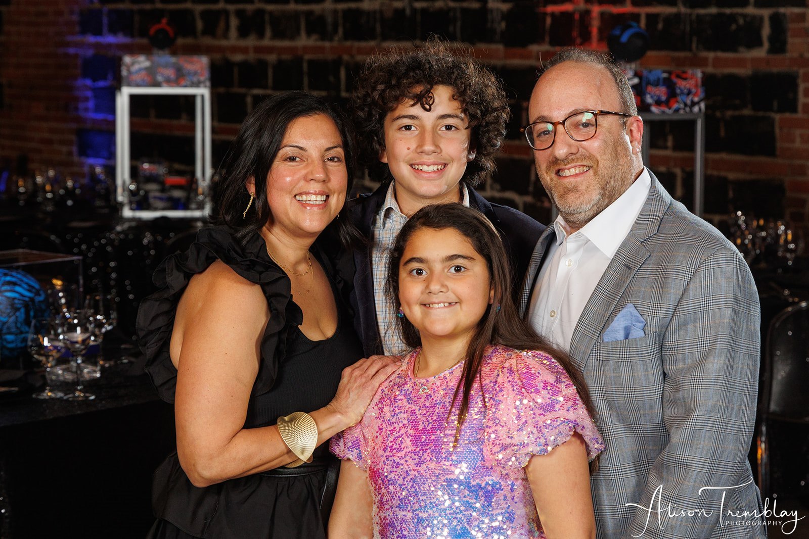 Lovely photo of Sebastian and his family. His awesome hair looks almost identical to the one in his logo below! at Sebastian's Graffiti and Sports Bar Mitzvah Party at Hook Hall in Washington, DC | Pop Color Events | Adding a Pop of Color to Bar & Bat Mitzvahs in DC, MD & VA | Photo by: Alison Tremblay