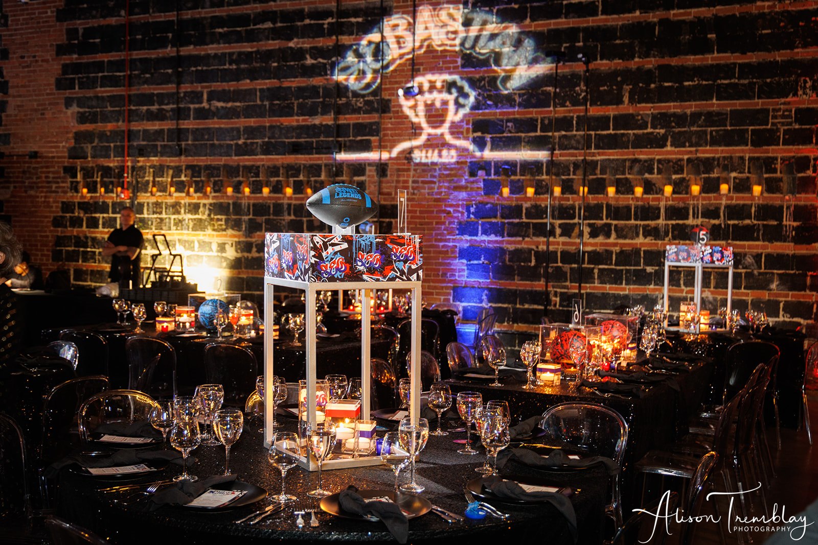 Bringing a touch of elegance with these sporty and graffiti decorations plus the custom gobo on the wall at Sebastian's Graffiti and Sports Bar Mitzvah Party at Hook Hall in Washington, DC | Pop Color Events | Adding a Pop of Color to Bar & Bat Mitzvahs in DC, MD & VA | Photo by: Alison Tremblay