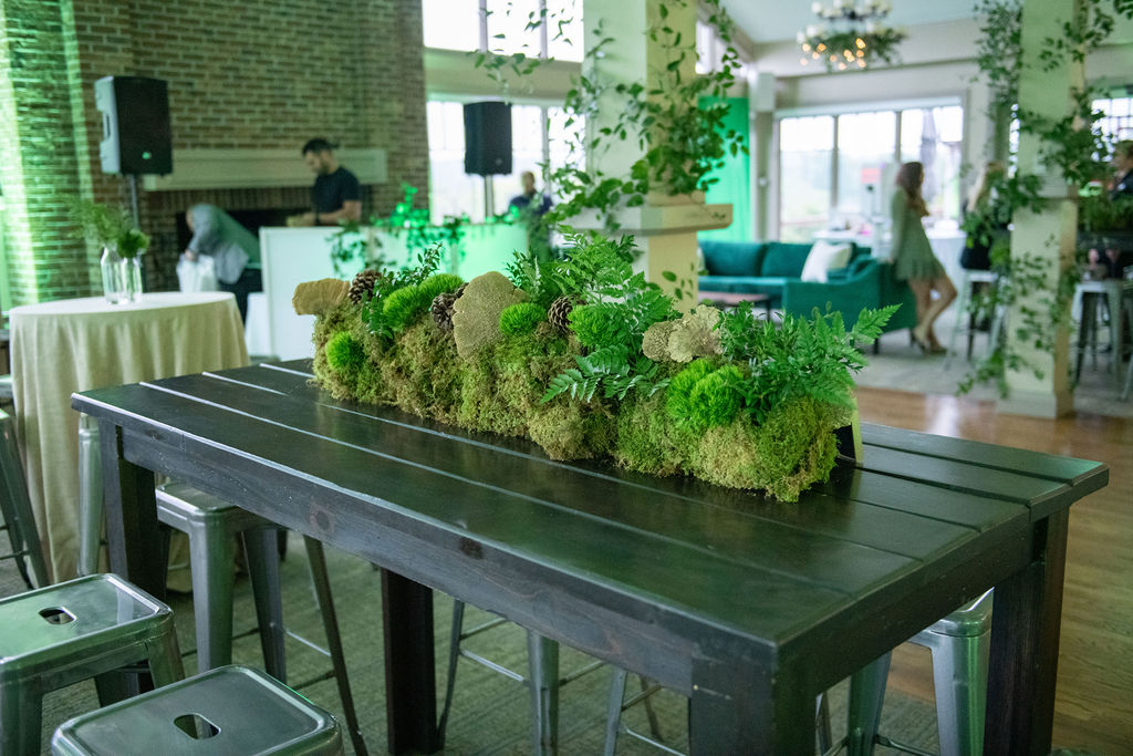 Long and round tables decorated with moss and other greenery at Rowan's Enchanted Forest B'nai Mitzvah at Bretton Wood Country Club in Germantown, MD | Pop Color Events | Adding a Pop of Color to Bar & Bat Mitzvahs in DC, MD & VA | Photo by: Lacey Ann Photography