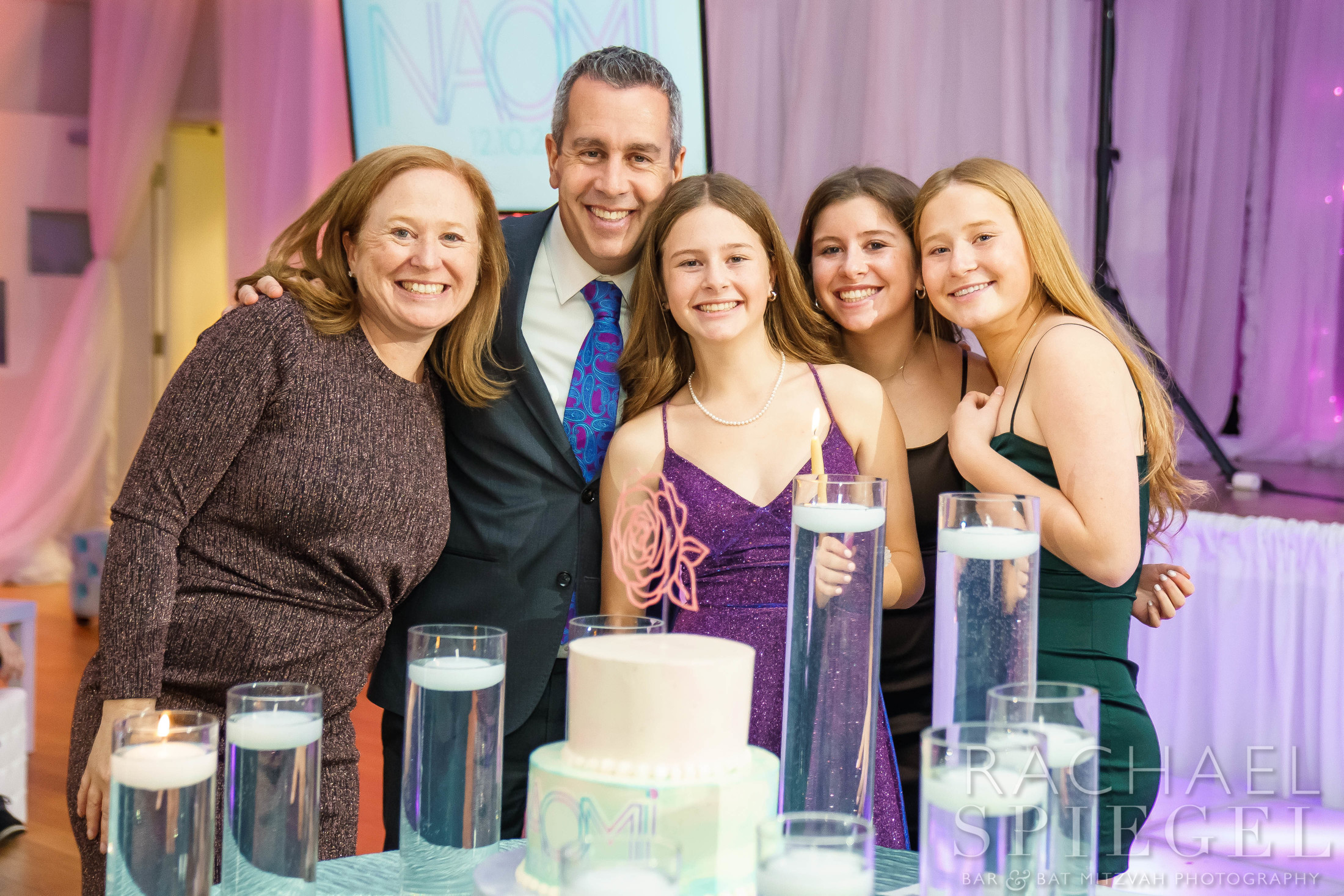 Naomi's pink, purple, blue and white pillow with her logo at Naomi's Pink and Purple Floral Bat Mitzvah Party at Temple Sinai in Washington, DC | Pop Color Events | Adding a Pop of Color to Bar & Bat Mitzvahs in DC, MD & VA | Photo by: Rachael Spiegel Photography