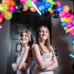 Eva and Lily and balloon arch at their Glowing Bat Mitzvah Party at the Bethesdan Hotel | Pop Color Events | Adding a Pop of Color to Bar & Bat Mitzvahs in DC, MD & VA | Photo by: Ana Isabel Photography