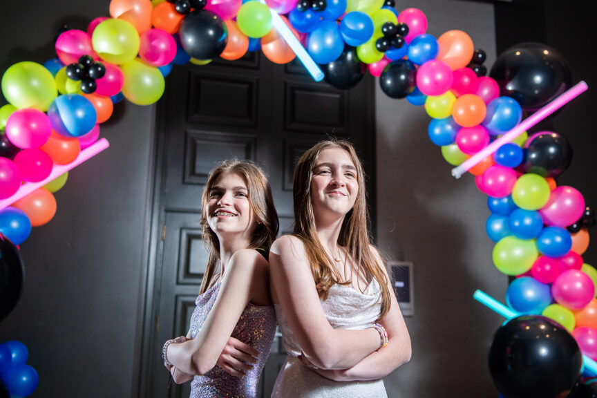 Eva and Lily and balloon arch at their Glowing Bat Mitzvah Party at the Bethesdan Hotel | Pop Color Events | Adding a Pop of Color to Bar & Bat Mitzvahs in DC, MD & VA | Photo by: Ana Isabel Photography