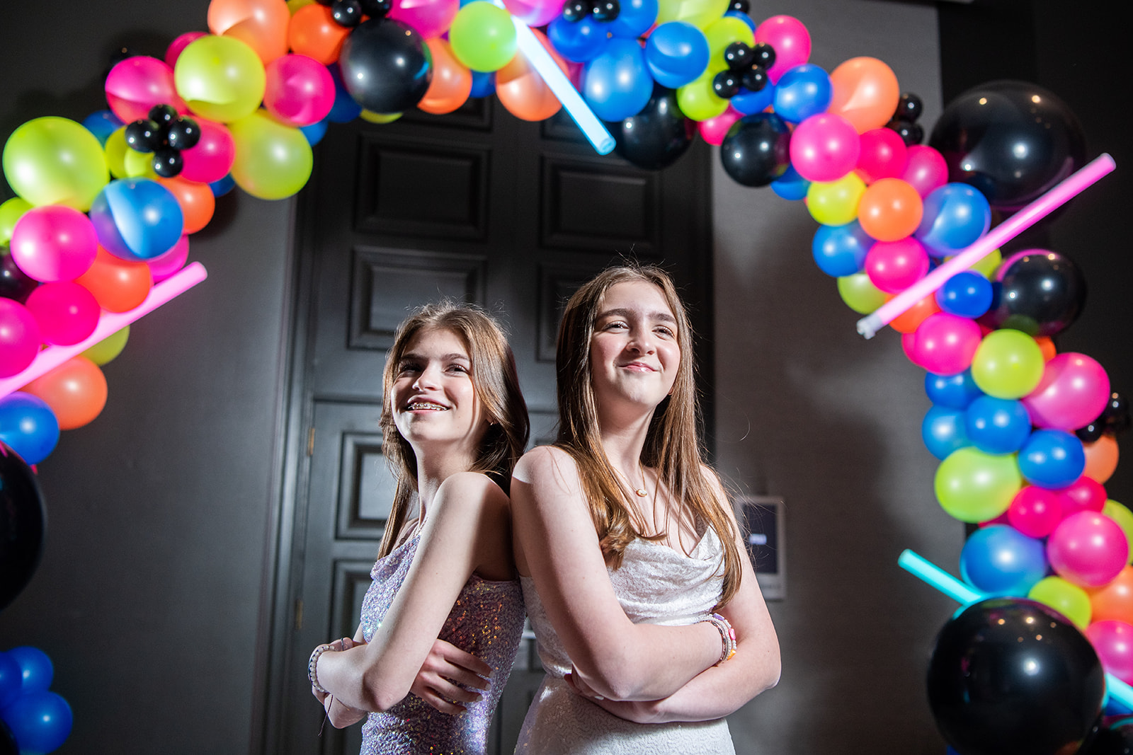 Eva and Lily and balloon arch at their Glowing Bat Mitzvah Party at the Bethesdan Hotel | Pop Color Events | Adding a Pop of Color to Bar & Bat Mitzvahs in DC, MD & VA | Photo by: Ana Isabel Photography