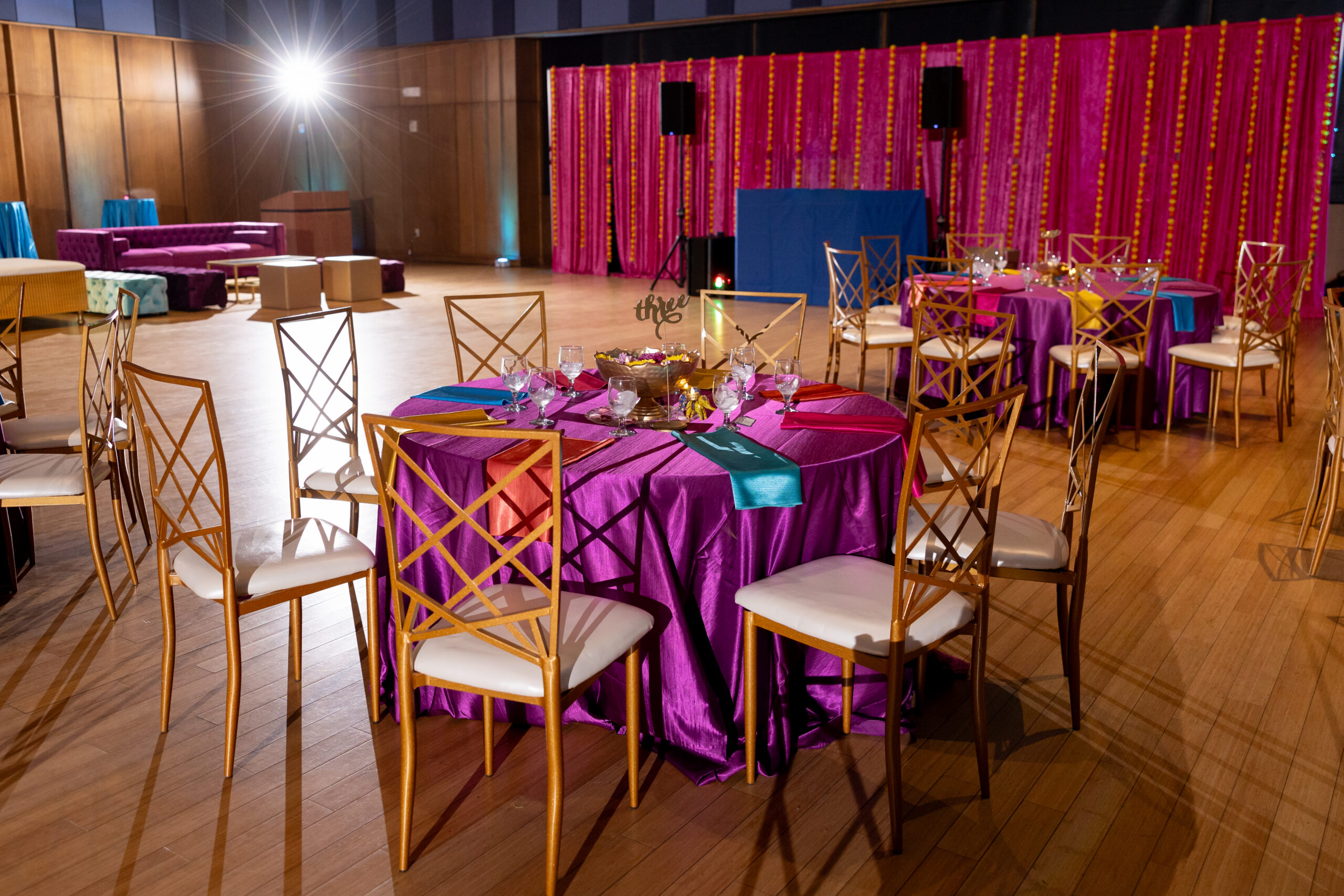 Table and dance floor back drop at Priya's Colorful Indian Fusion Bat Mitzvah Party at Silver Spring Civic Building | Pop Color Events | Adding a Pop of Color to Bar & Bat Mitzvahs in DC, MD & VA | Photo by: Jessica Latos Photography