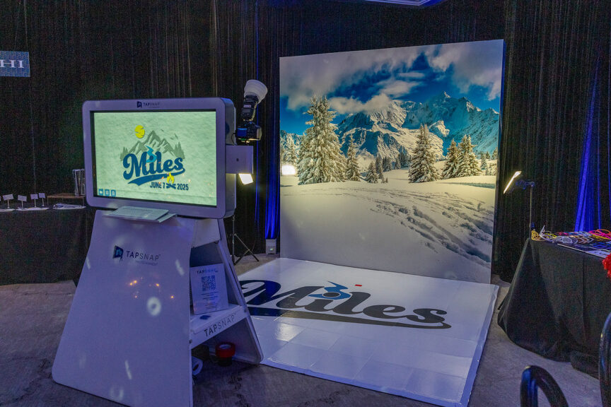 Guests pose in front of snowy mountain photo booth backdrop with TapSnap setup. | Pop Color Events | Adding a Pop of Color to Bar & Bat Mitzvahs in DC, MD & VA | Photo by: Alejandro Maldonada Photography